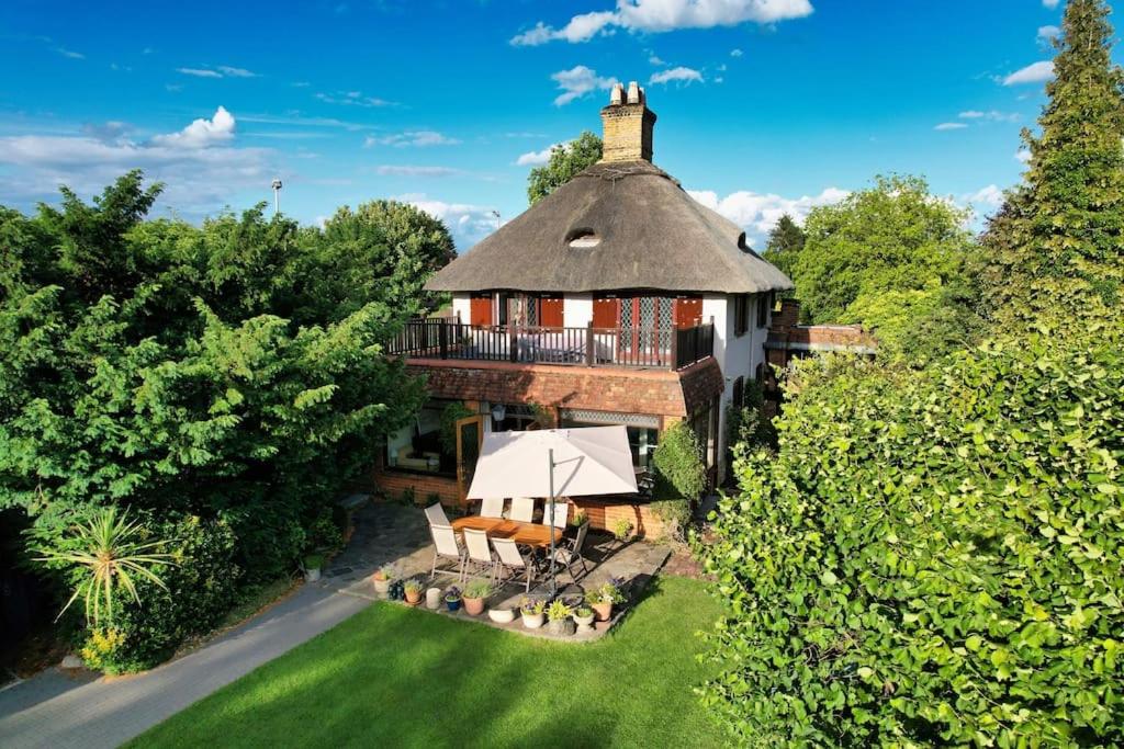 an aerial view of a house with a roof at Old Wharf Cottage - Riverside Living with Pool in Wraysbury