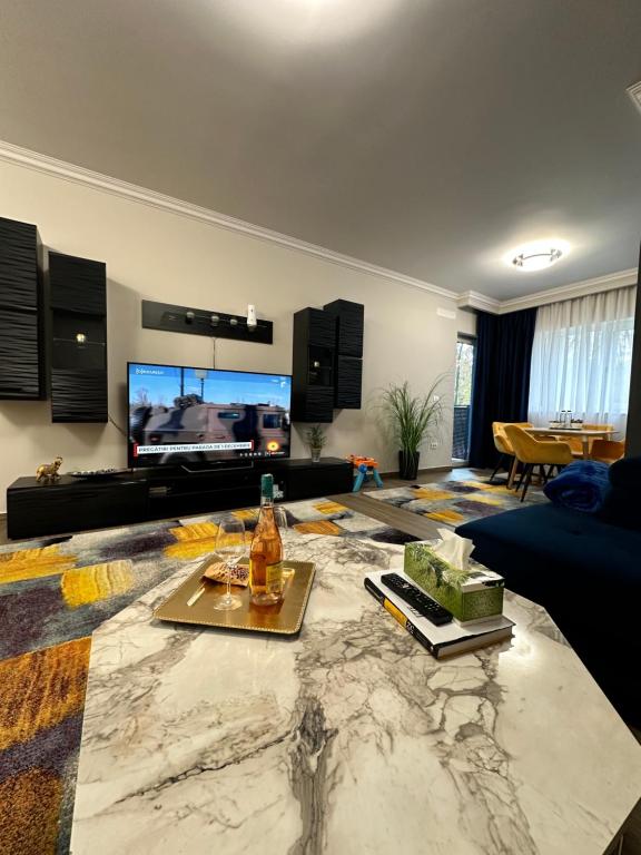 a living room with a couch and a tv at Dylara de lux apartament in Timişoara