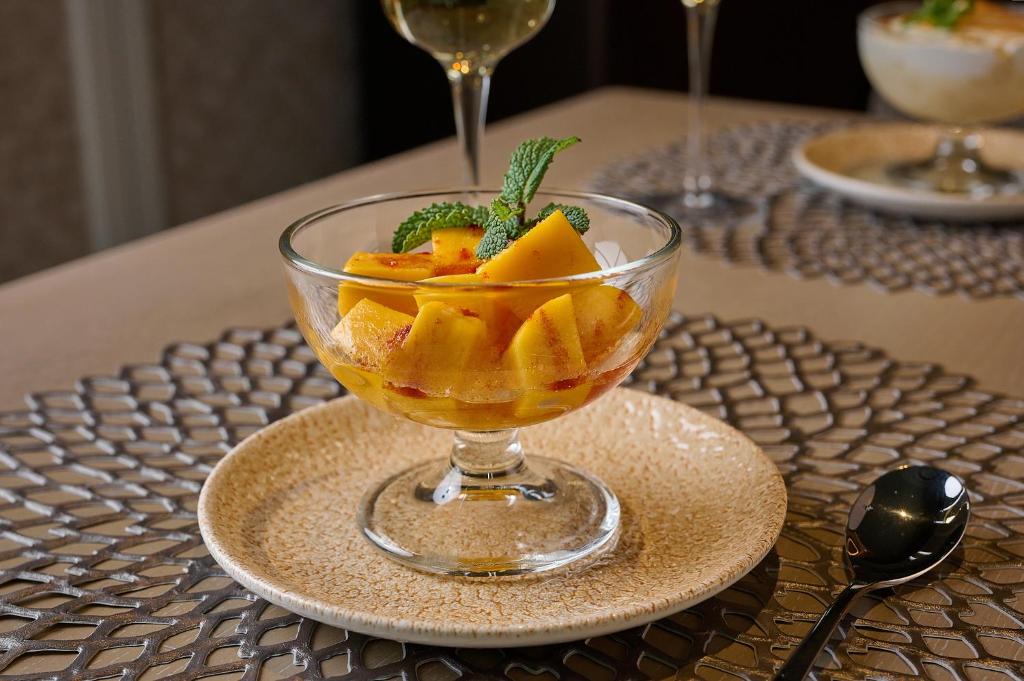 a glass bowl of fruit on a plate on a table at VP Madroño in Madrid