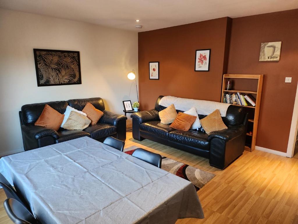 sala de estar con sofá y mesa en Granite Getaways - Union Skyview en Aberdeen