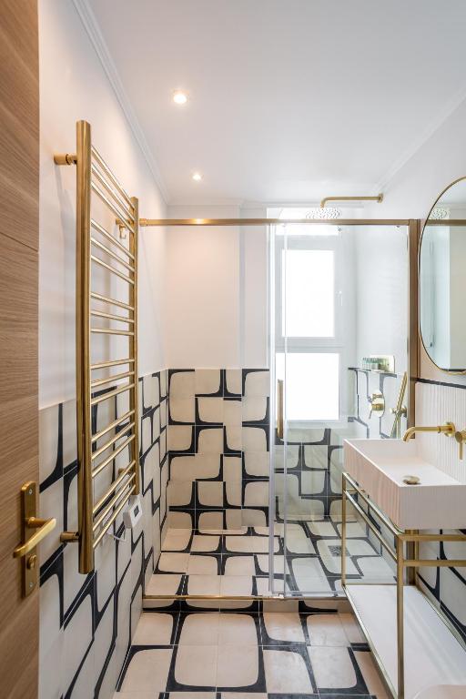 a bathroom with a sink and a mirror at The Blue Suite Downtown Montmartre in Paris