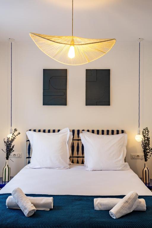 a bedroom with a large bed with two towels on it at The Blue Suite Downtown Montmartre in Paris