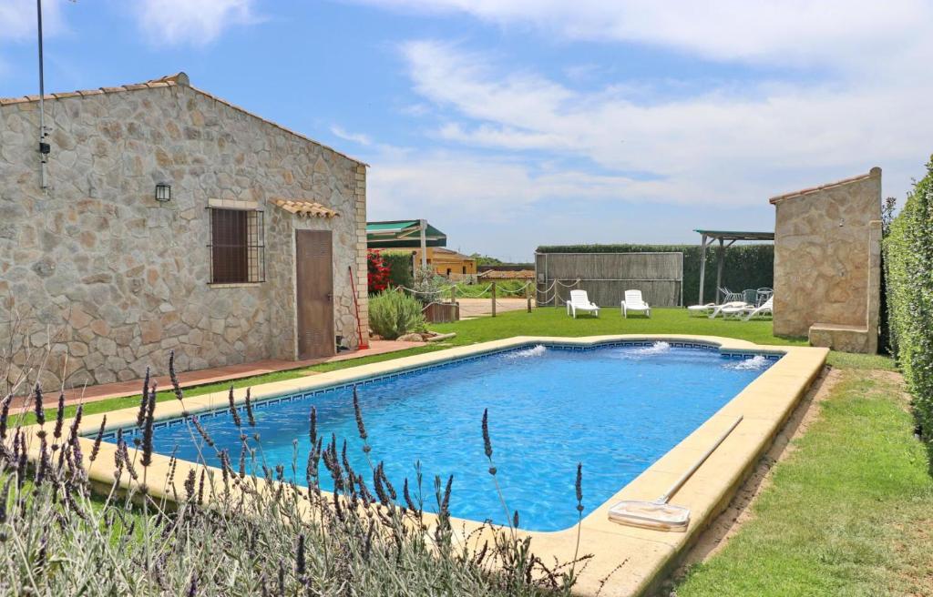 a pool in a yard next to a building at Chalet Piedra in Conil de la Frontera