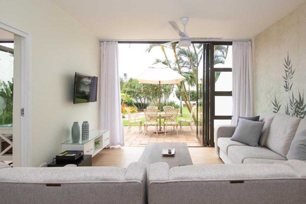 a living room with a couch and a table at 210 Breakers Resort Umhlanga Rocks in Durban