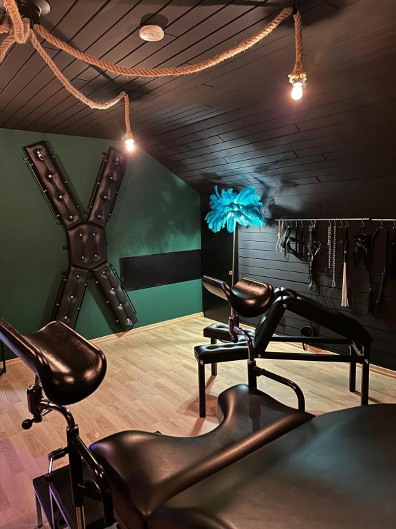 a barber shop with two chairs in a room at Emotion Apartments- BDSM Apartment mit privater Sauna in Vlotho