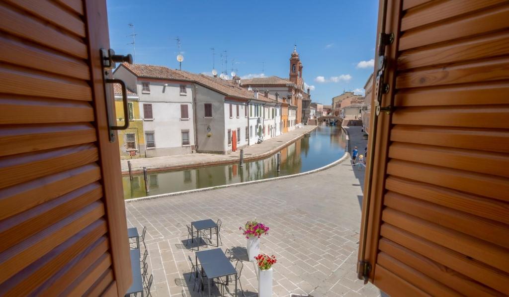 a view from a window of a street with a canal at Locanda del Delta in Comacchio