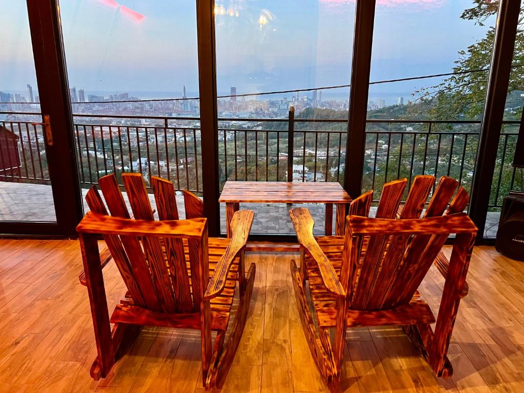 two chairs and a table on a balcony at Dream Panorama Cottage in Batumi