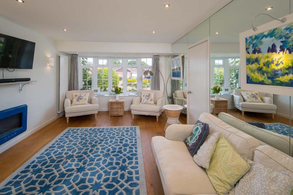 a living room with a couch and a fireplace at 40 Trelawny Way in Bembridge