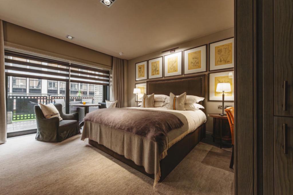 a bedroom with a large bed and a large window at Dakota Leeds in Leeds