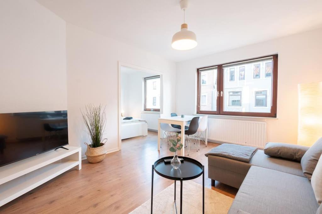 uma sala de estar com um sofá e uma mesa em EXKLUSIVE 2-Zimmer Wohnung Bremen Neustadt 6 em Bremen