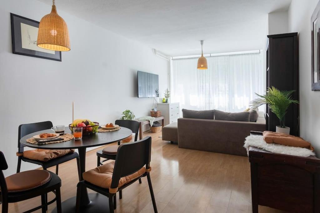 a living room with a table and chairs and a couch at 2-Bedroom Apt Near City Center in Zagreb