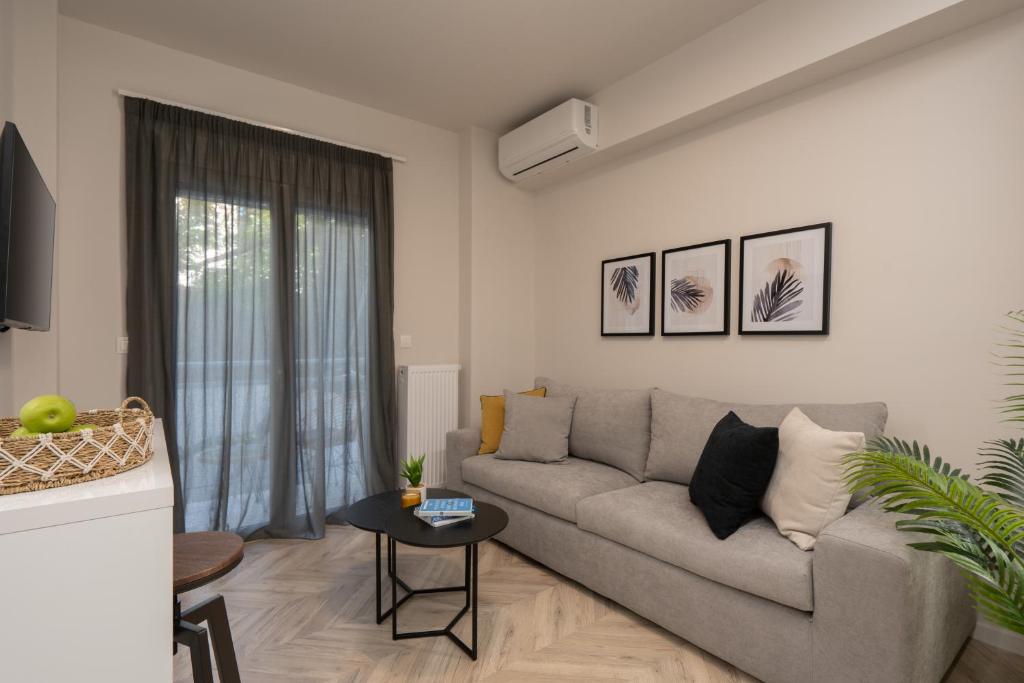 a living room with a couch and a table at Charming two bedrooms Apartment walk to Acropolis in Athens