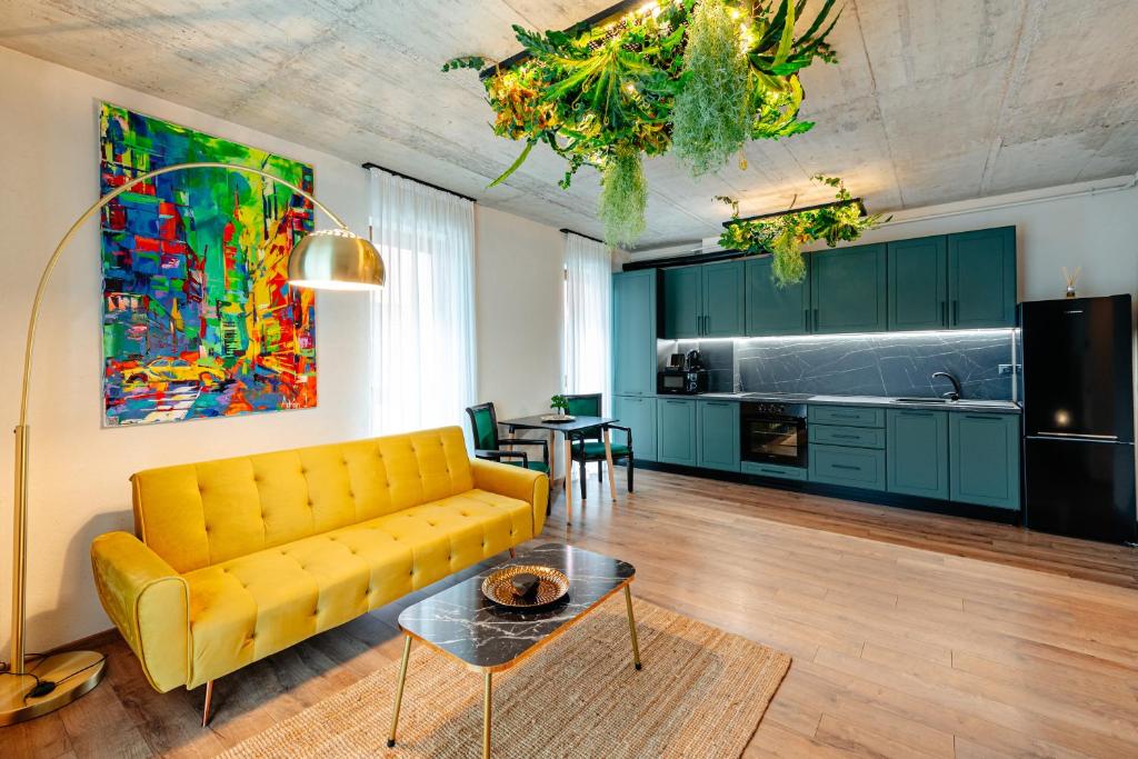 a living room with a yellow couch and a table at Centro Accommodation in Cluj-Napoca
