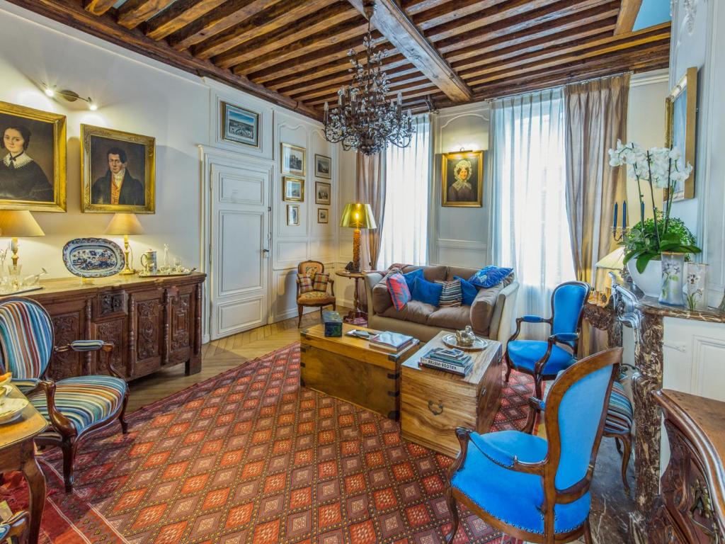 a living room with a couch and a table at Room in Guest room - This 10th Century home sits in an exceptional setting in the center of Orleans in Orléans