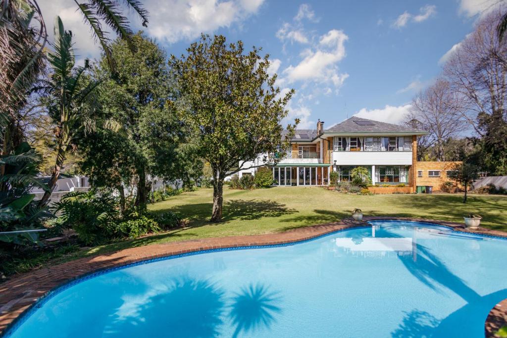 una gran piscina frente a una casa en Owls Loft Guesthouse, en Johannesburgo