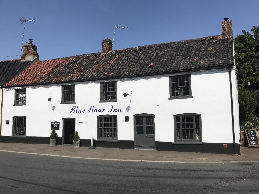 a white building on the side of a street at Blue Boar Inn in Great Ryburgh
