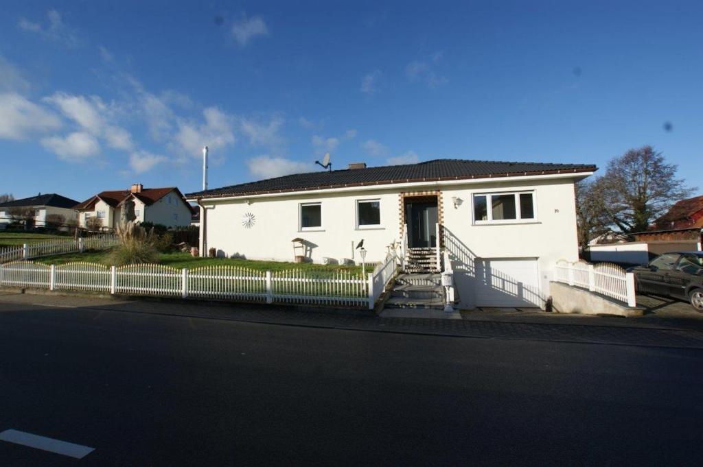 a white house on the side of a street at Ferienhaus Landhaus Klein in Erbach