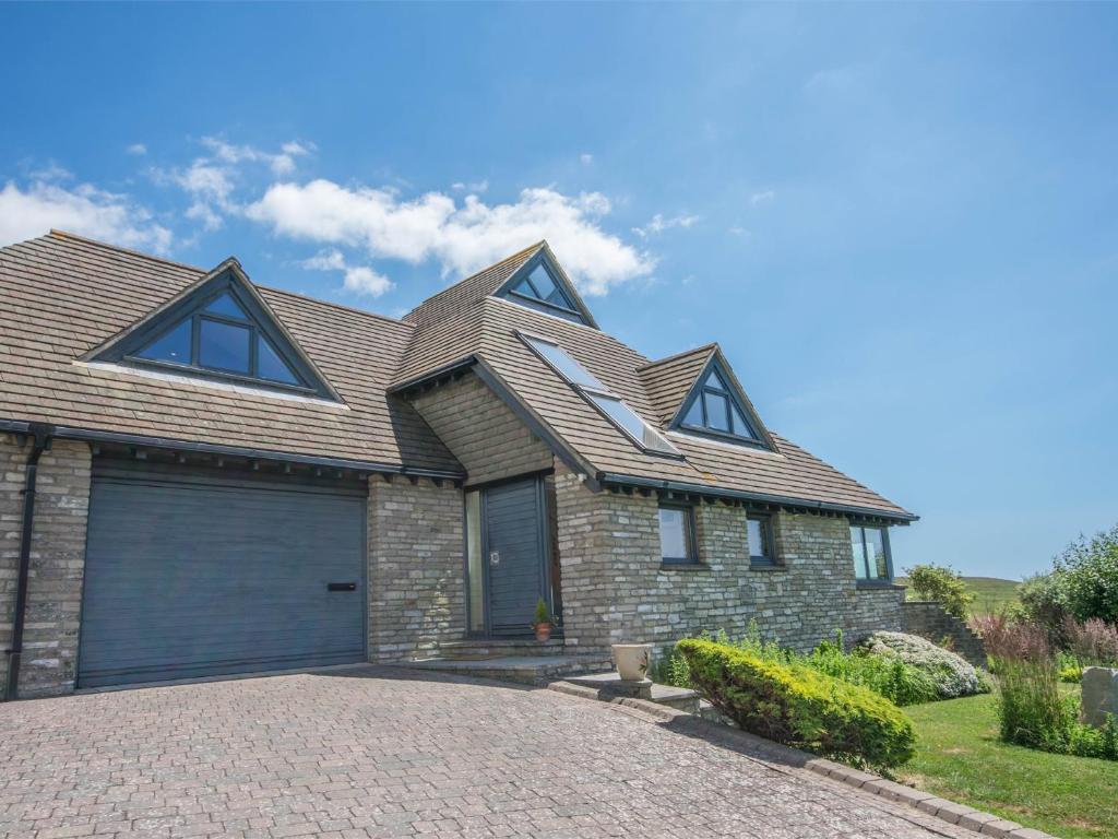 a house with a gambrel roof and a garage at 3 Bed in Worth Matravers DC063 in Worth Matravers