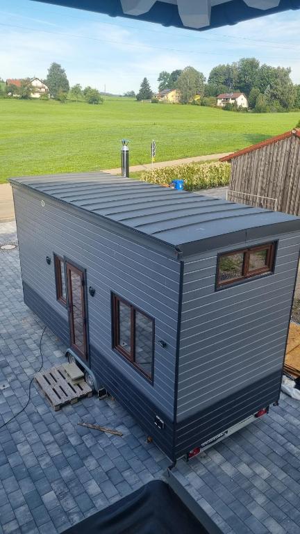 a tiny house sitting on top of a patio at Tiny House Flexhome in Buchenberg