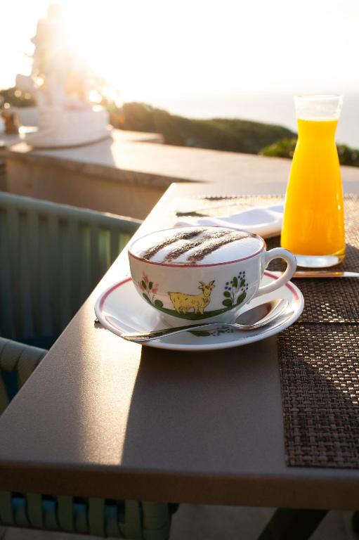 a cup of coffee on a plate on a table at La Chèvre d'Or in Éze