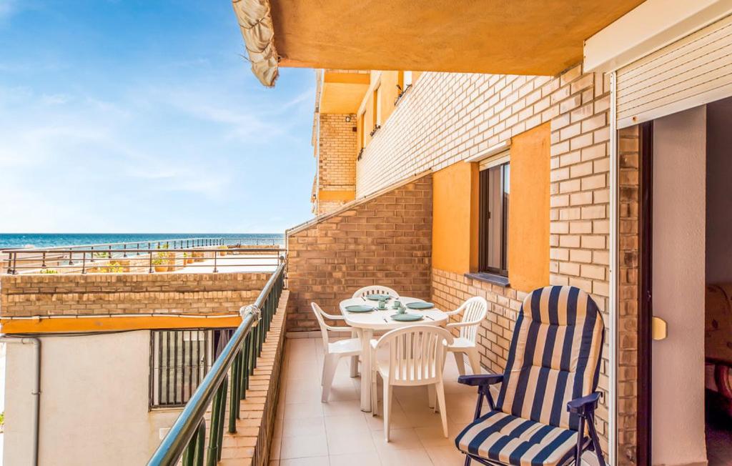 a balcony with a table and chairs and the ocean at Stunning apartment in Oropesa del Mar in Oropesa del Mar