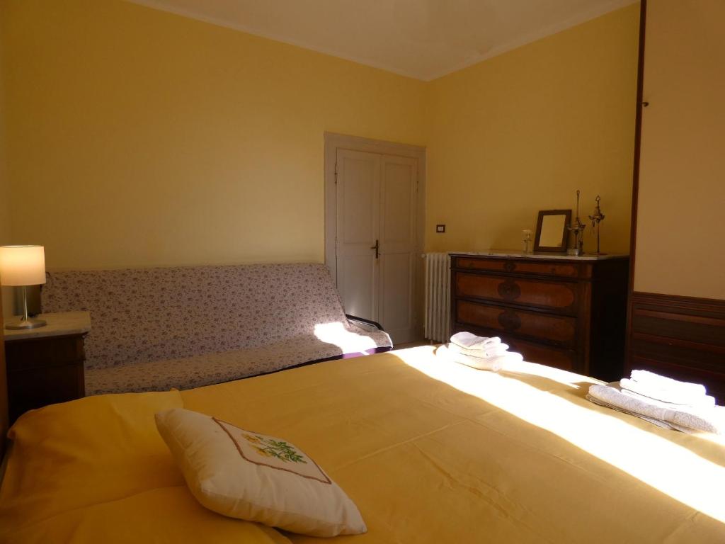 Postel nebo postele na pokoji v ubytování Scappo in Umbria, la Loggia