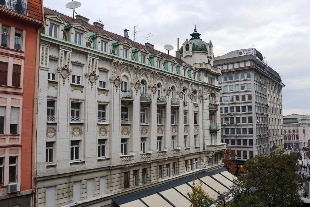 a large white building with a clock tower on top at Golden Velvet apartment Belgrade in Belgrade