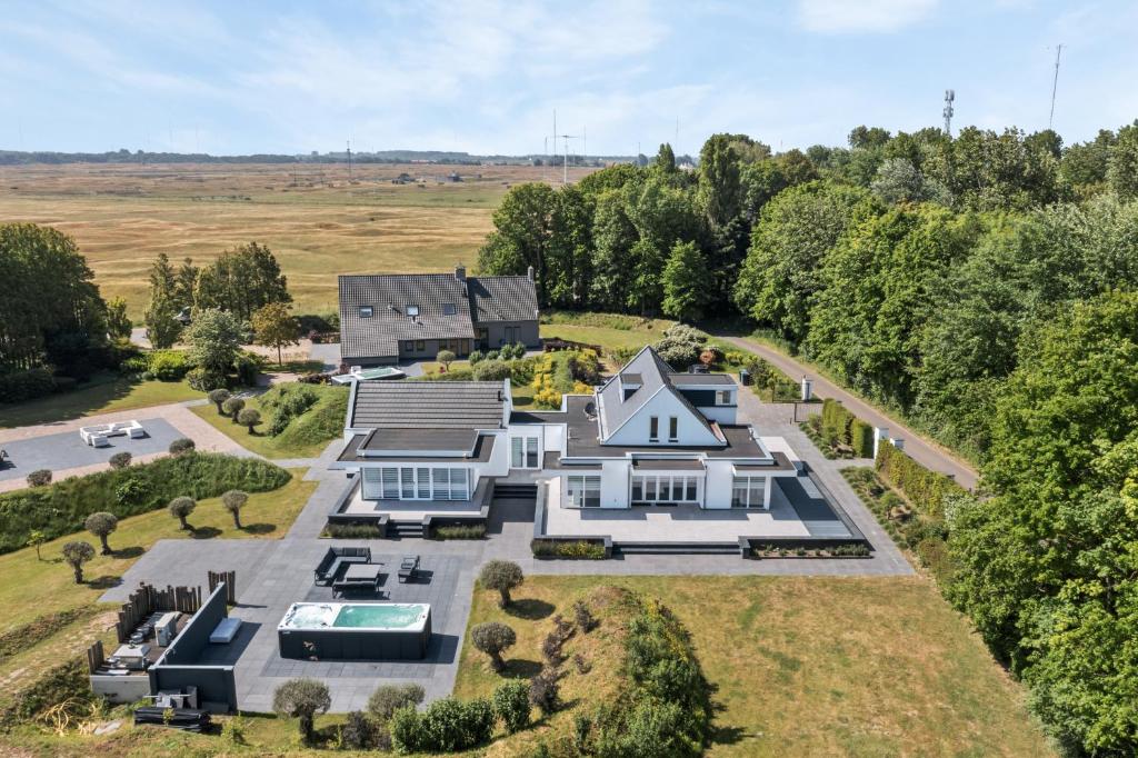 an aerial view of a large white house at Landgoed Hermitage - Villa Minerva - XXL Zwemspa - max 16 personen in Ouddorp