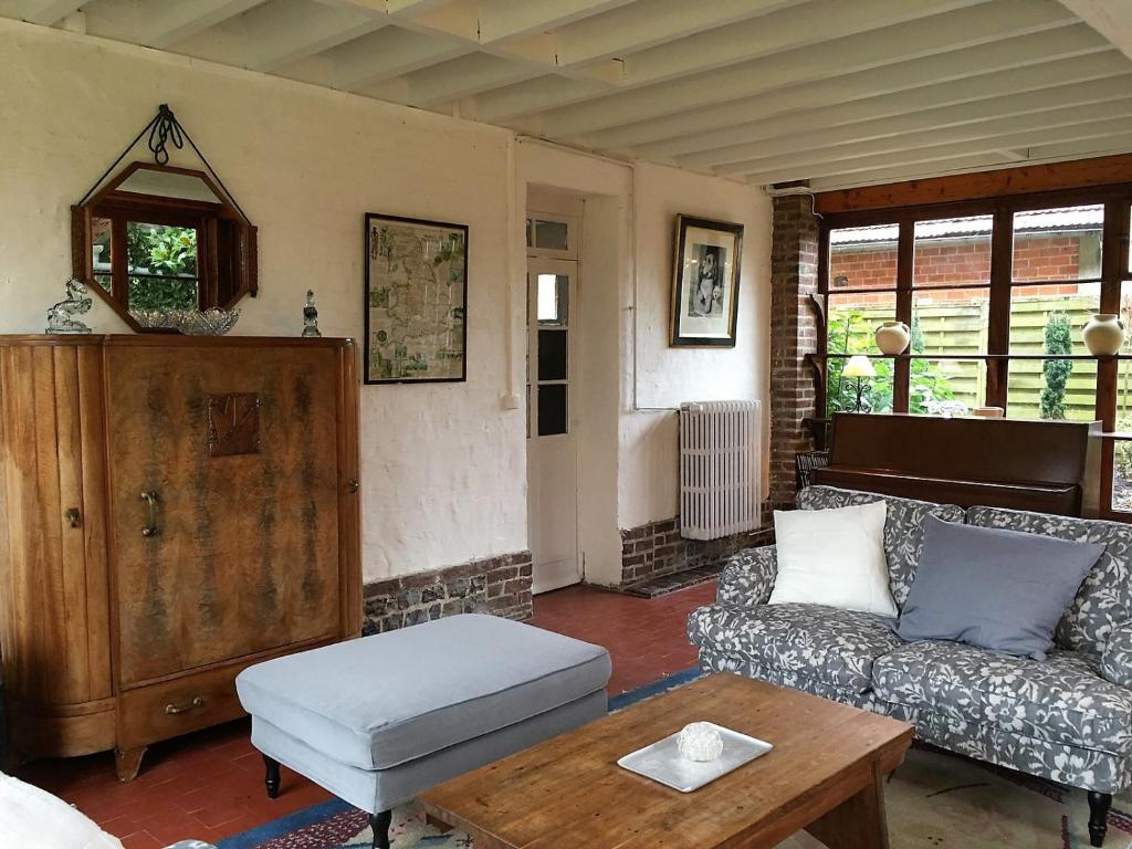 a living room with a couch and a coffee table at Grand Clos Normand in Varengeville-sur-Mer