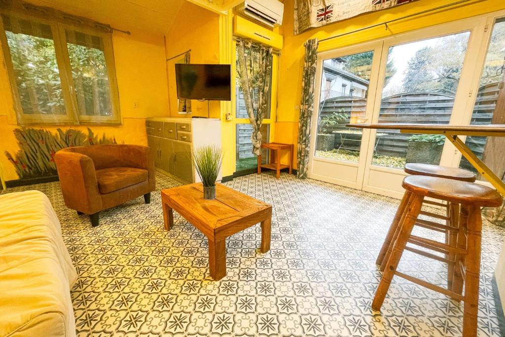 a living room with a couch and a table at #M1 La maisonnette des 3 ponts Terrace in Saint-Égrève