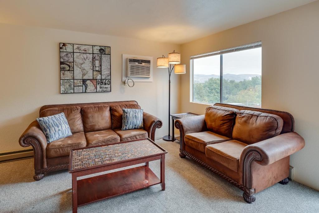 a living room with leather furniture and a window at Lewiston Vacation Rental with Nearby River Access! in Lewiston