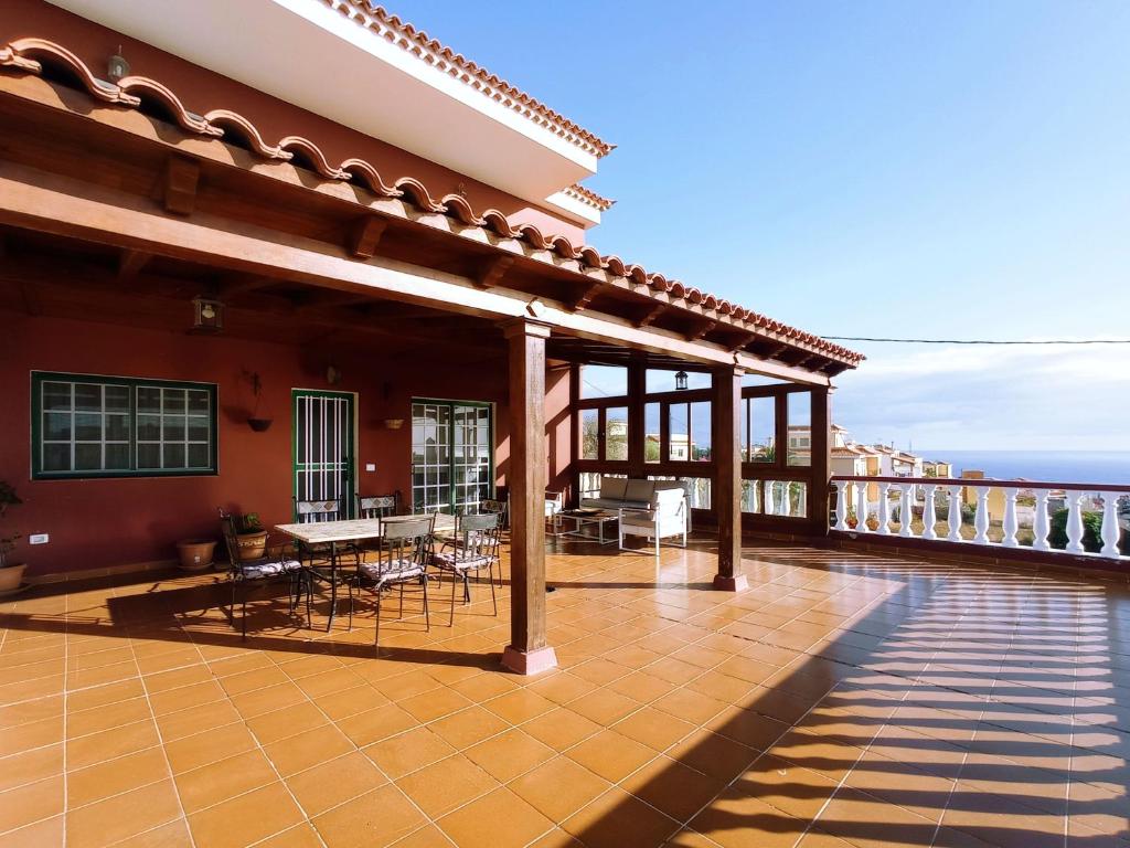 a patio with tables and chairs on a balcony at LIVE GUANCHES DE CANDELARIA in Candelaria