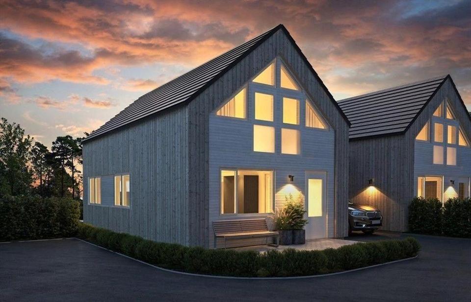 a rendering of a house with a garage at Barnevennlig feriehus ved sjøen in Kristiansand