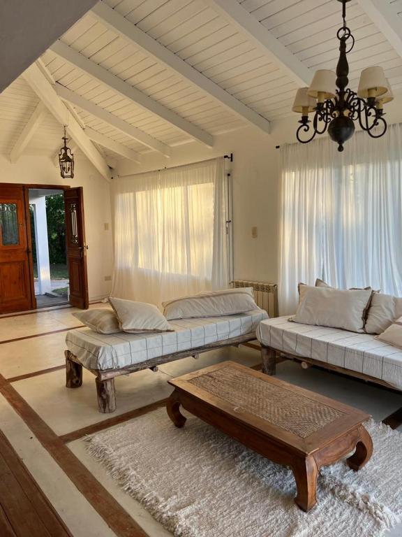 a living room with two beds and a table at Homestay Victoria Entre Rios in Victoria