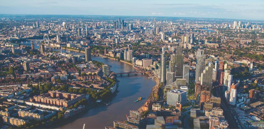 an aerial view of a large city with a river at CENTRAL LONDON STAY-Fabulous Ultra-Central London Luxury Designer One Bedroom Flat with inner garden view balcony AC and kitchen in London