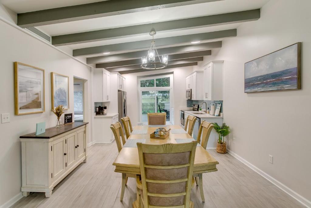 a kitchen and dining room with a table and chairs at Bright Jekyll Island Home with Deck Less Than 1 Mi to Beach in Jekyll Island