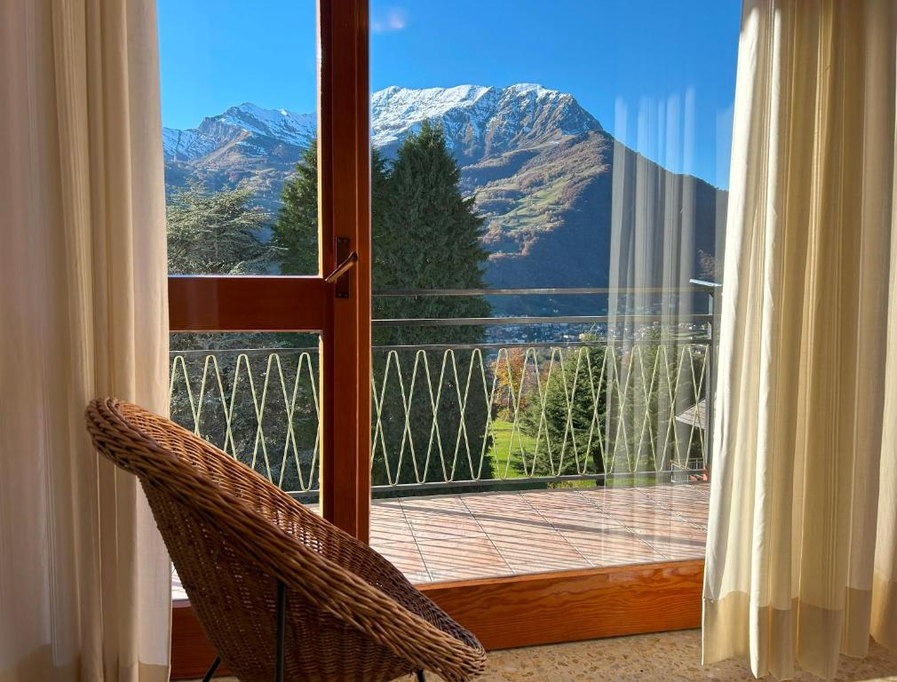 a door to a balcony with a view of a mountain at Bellavista - Residence in Barzio center near free ski shuttle in Barzio