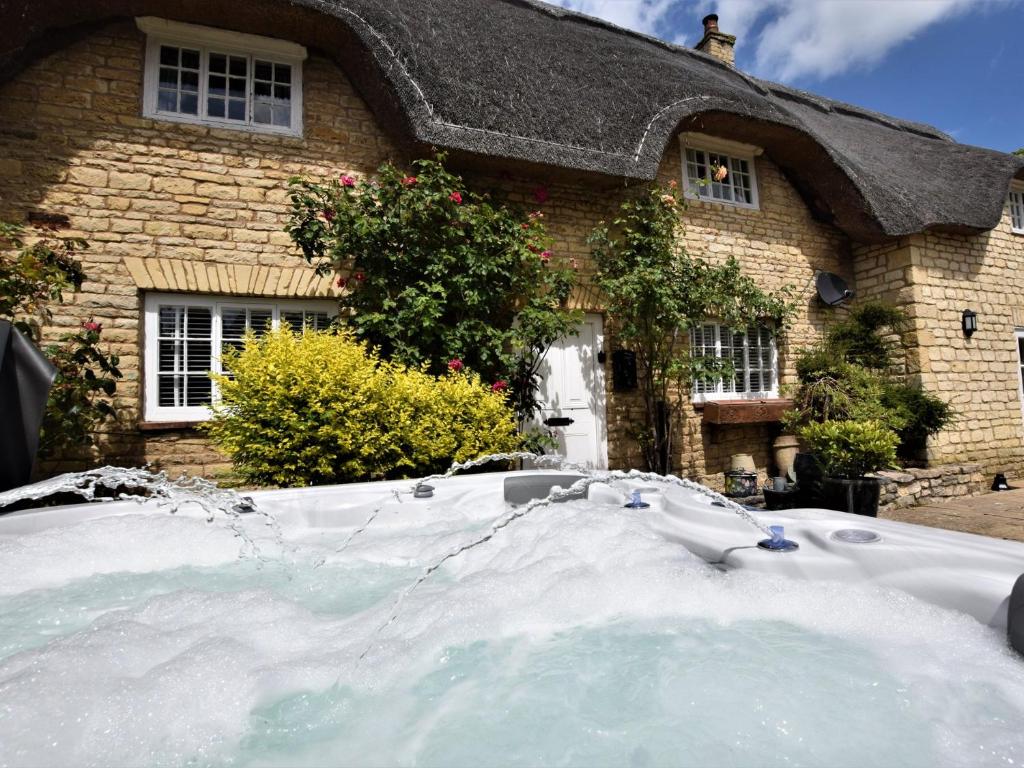 a house with a pile of snow in front of it at 4 bed in Rutland Water 86556 in Empingham
