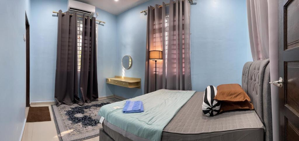 Dormitorio pequeño con cama y espejo en Homestay ShimahJay Umbai Melaka, en Melaka