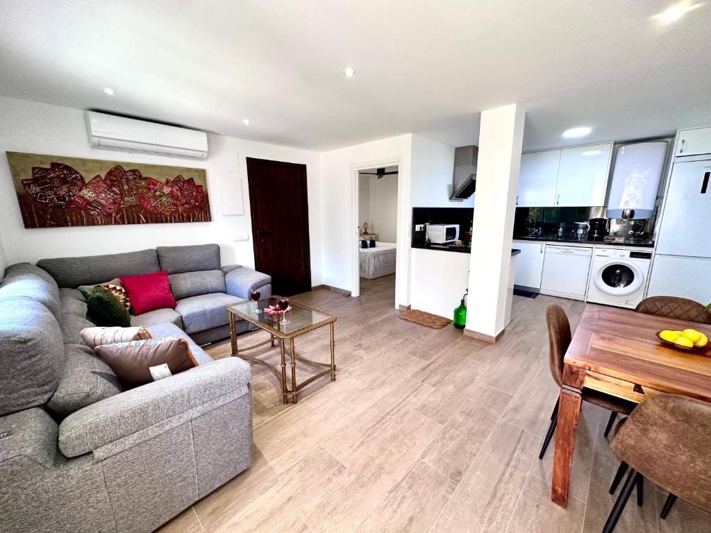 a living room with a couch and a table at Apartamento La cala del Moral SOL y MAR in Cala del Moral