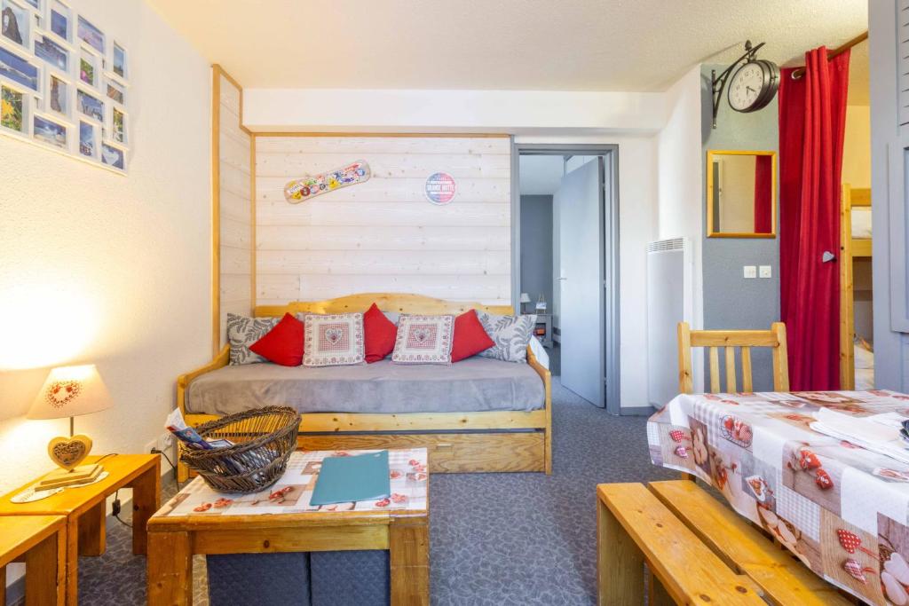 a bedroom with a bed and a table and two tables at T2 Tignes Val Claret in Tignes