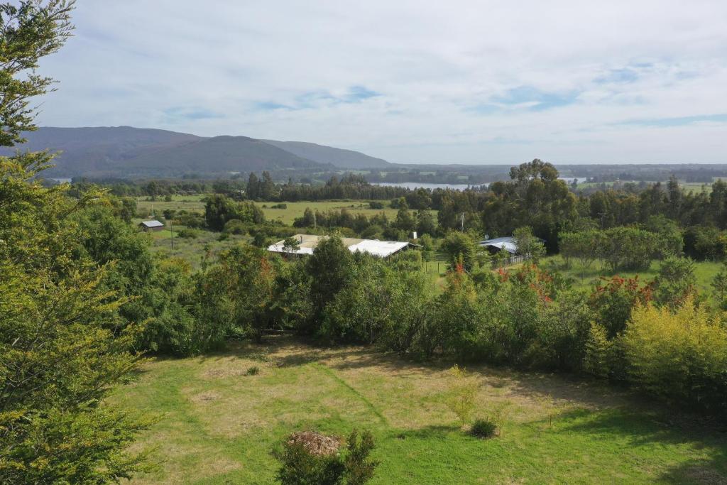 a view of a field with trees and houses at Suite con jacuzzi y bellas vistas in Lanalhue Lake