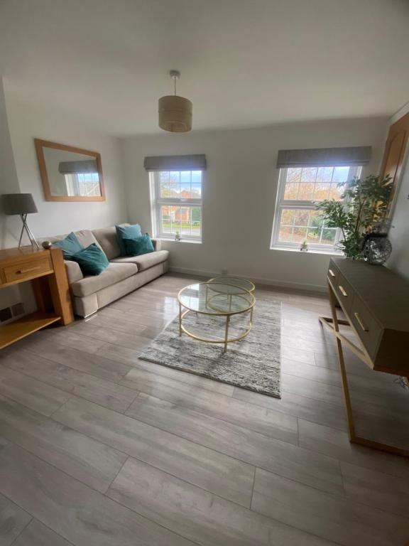 a living room with a couch and a table at Cosy Apartment in Wetheral,Cumbria in Wetheral