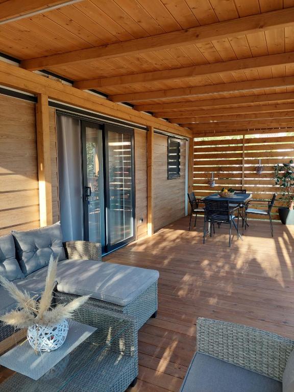 a patio with a couch and a table on a deck at Julija Mobile Lux in Vodice
