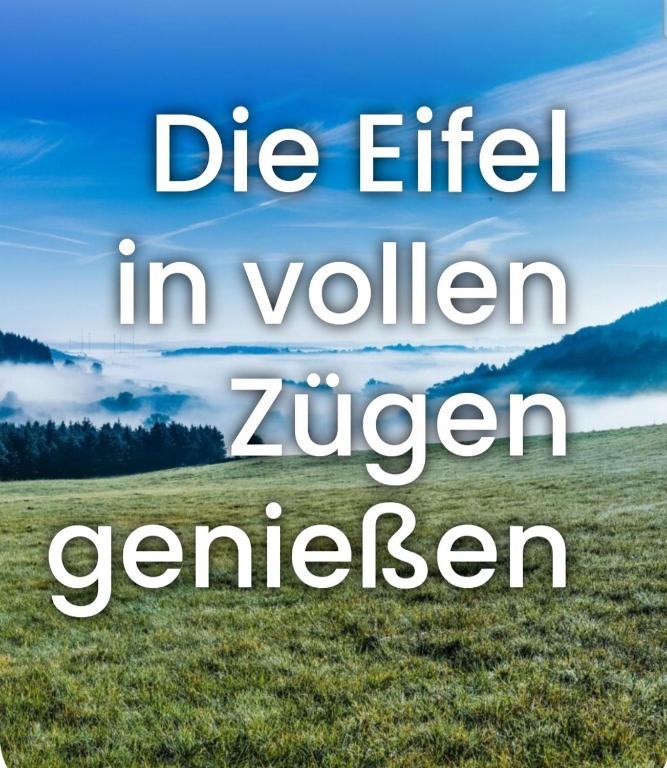 a field of grass with the words die ethical in yellow zigergengenen at Ferienwohnung Miesseler in Kall