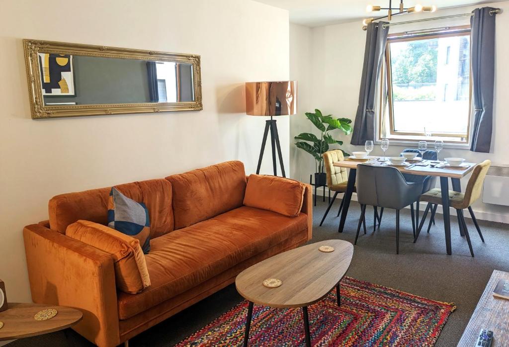 a living room with a couch and a table at Beautiful Modern Coventry City Centre Apartment in Coventry