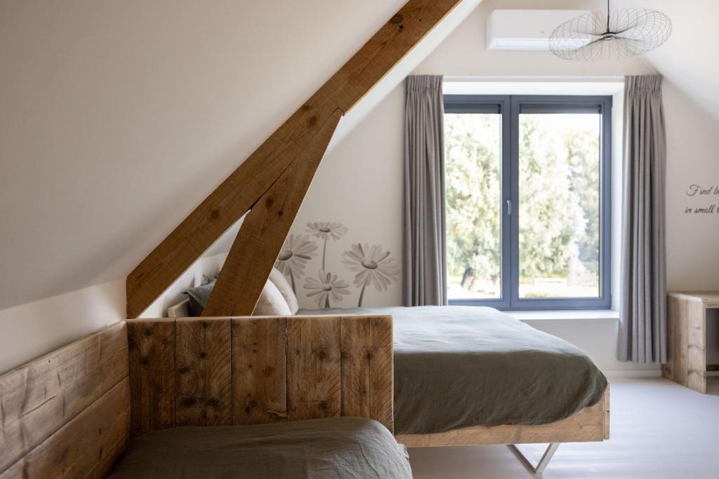 Postel nebo postele na pokoji v ubytování B&B Ginnekenshoeve