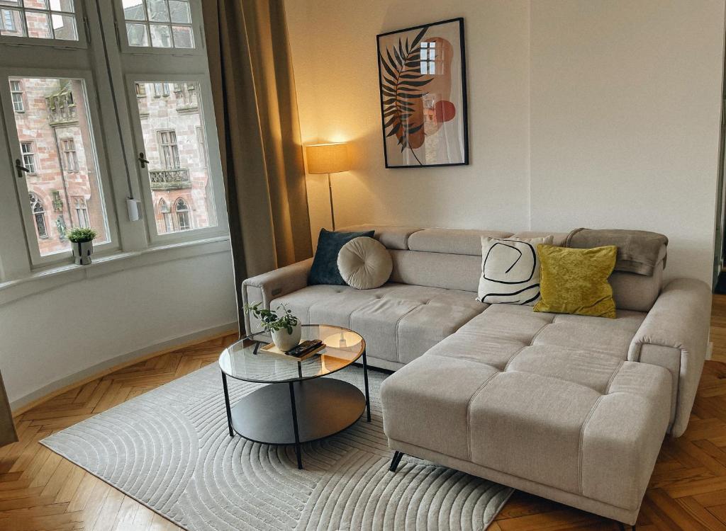 a living room with a couch and a table at Exklusives Apartment im Herzen Saarbrückens in Saarbrücken