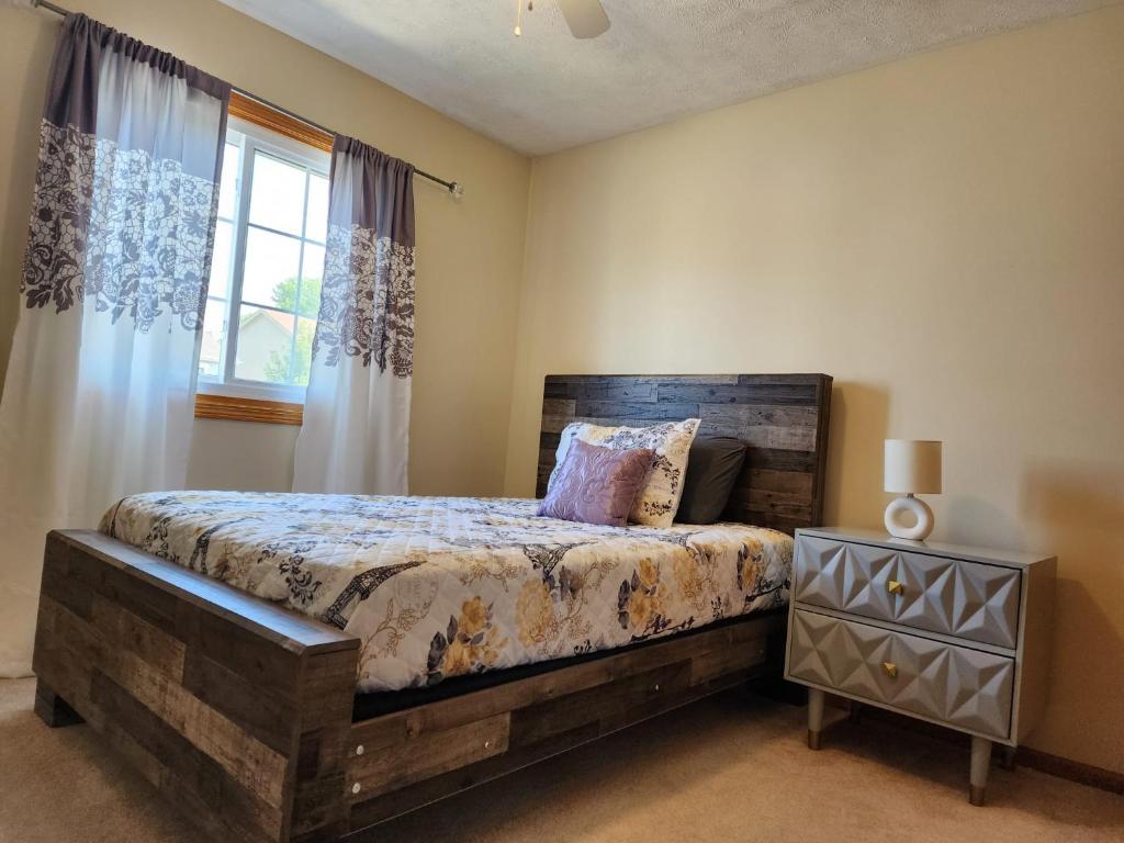 a bedroom with a bed and a window at Pet friendly,3 Queen beds, One-Full bed with Fast free WIFI in Omaha