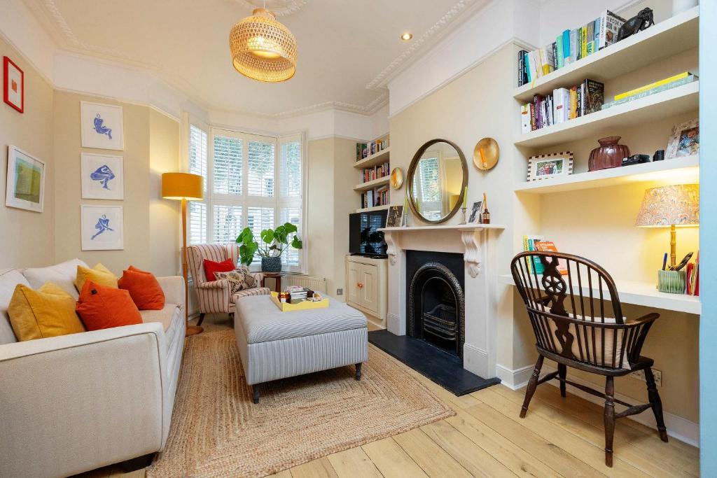 a living room with a white couch and a fireplace at Veeve - Sunshine Joy in London